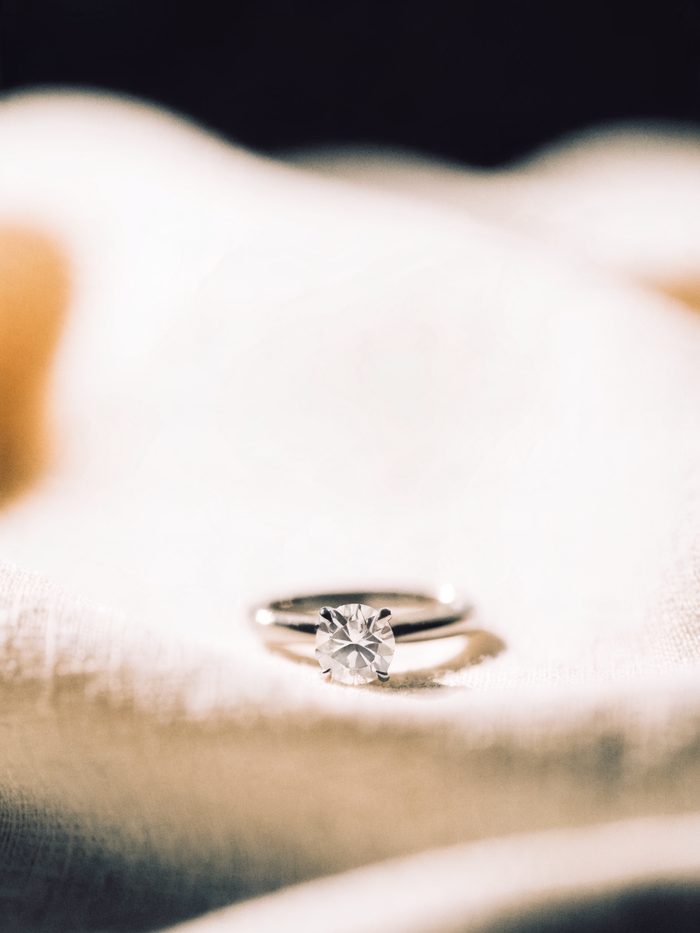 A round brilliant diamond solitaire ring in platinum on linen