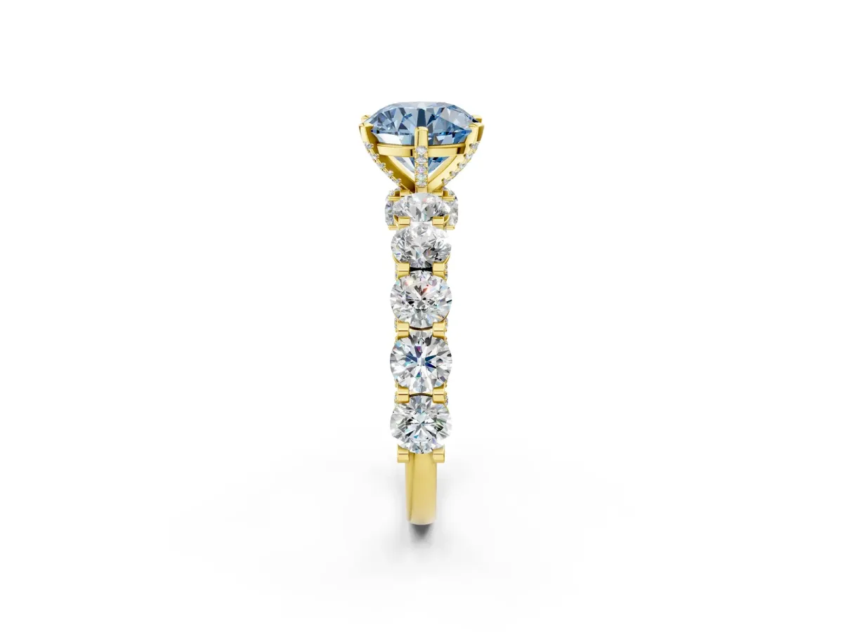 Fancy Blue Round Cut Diamond Side Stone Engagement Ring with Four-Prong Setting Yellow gold