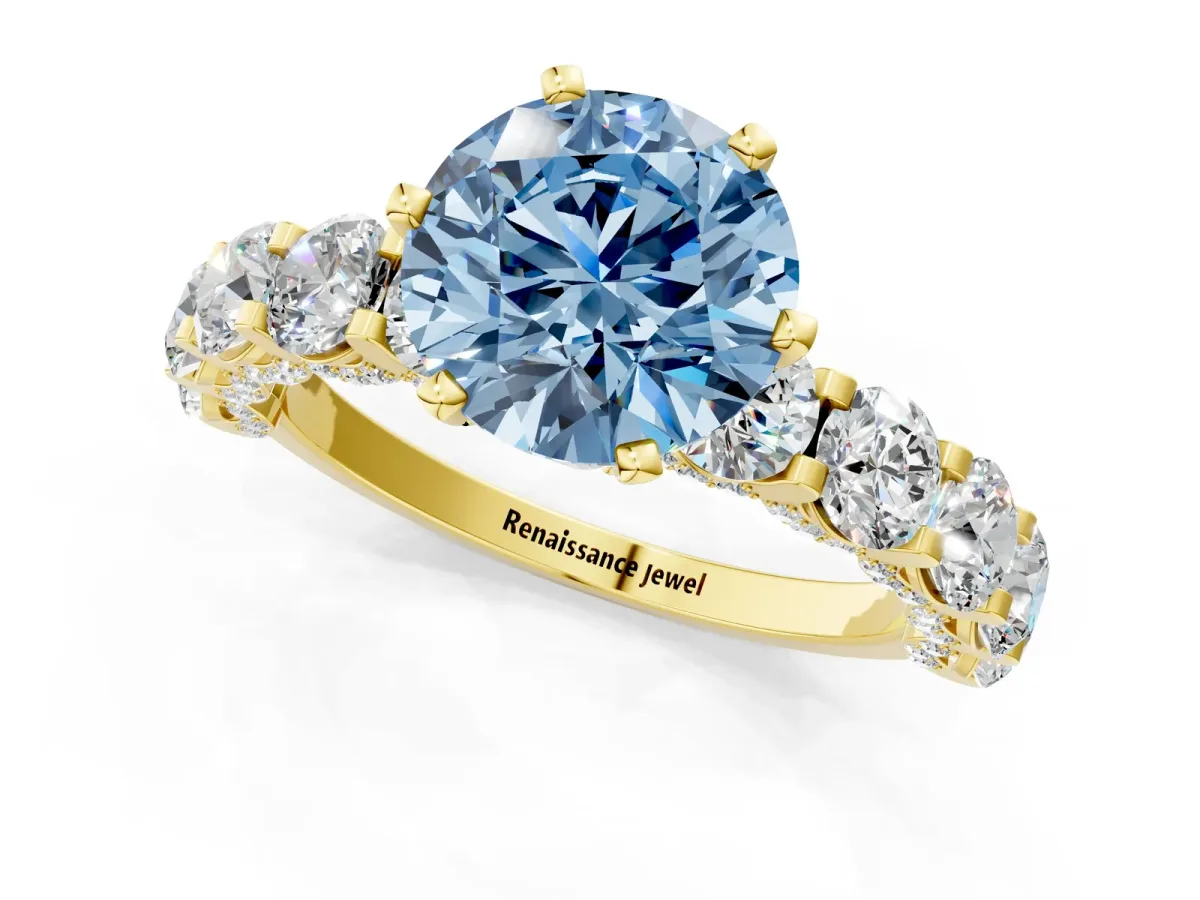 Fancy Blue Round Cut Diamond Side Stone Engagement Ring with Four-Prong Setting Yellow gold