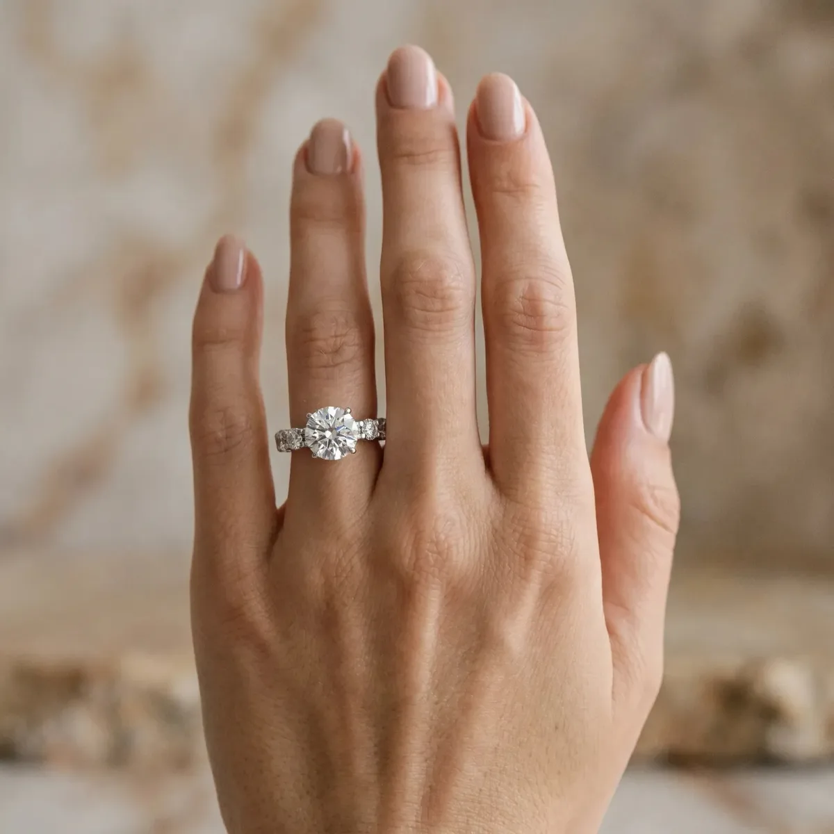 Round Cut Diamond Side Stone Engagement Ring with Four-Prong Setting White gold