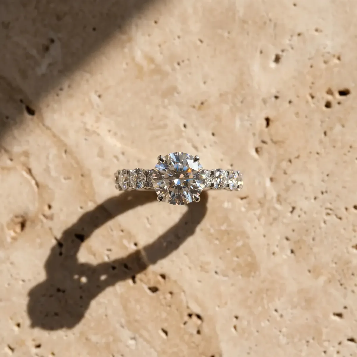 Round Cut Diamond Side Stone Engagement Ring with Four-Prong Setting White gold
