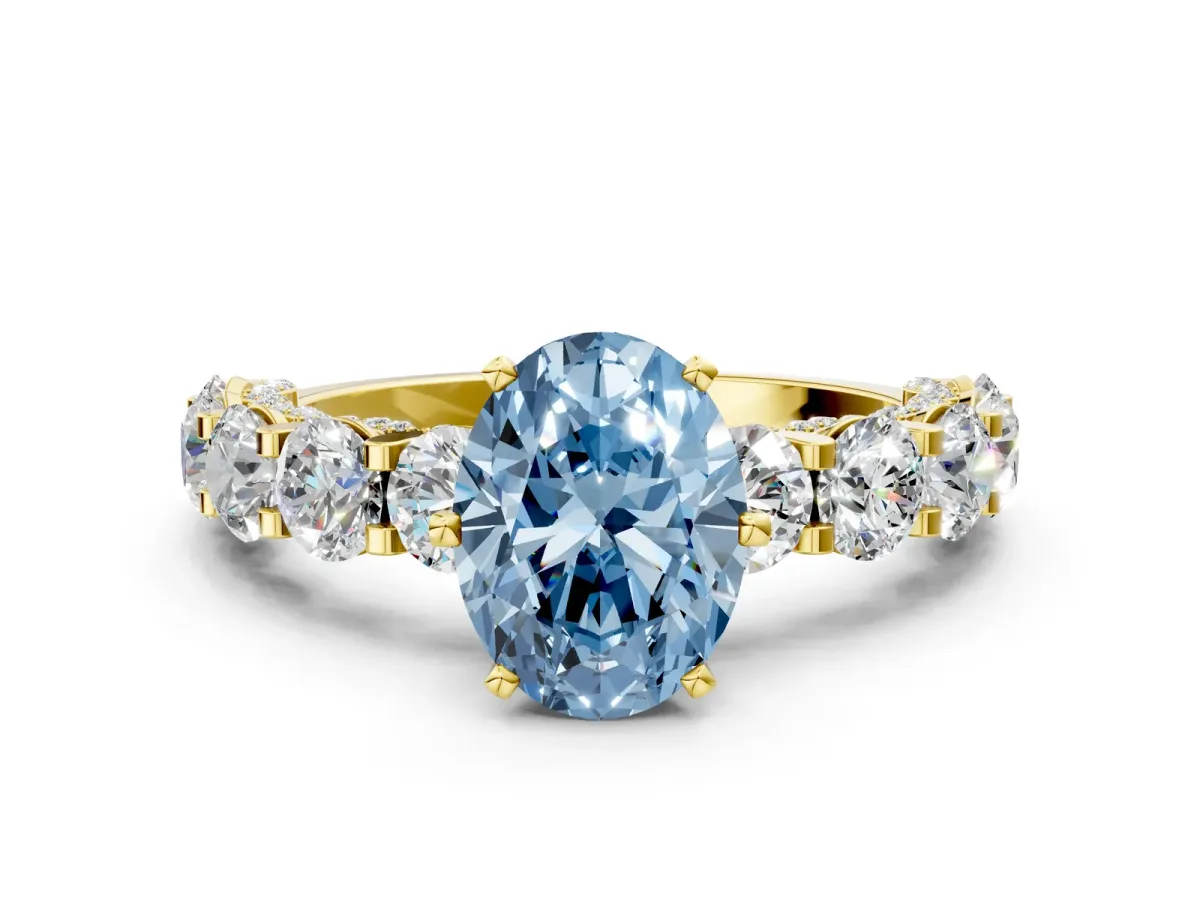 Fancy Blue Oval Cut Diamond Side Stone Engagement Ring with Four-Prong Setting Yellow gold