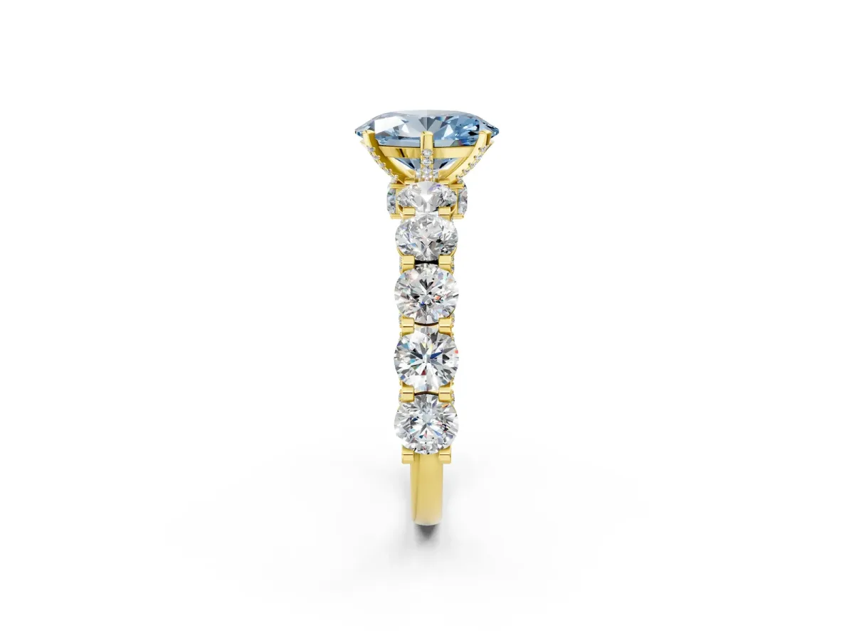 Fancy Blue Oval Cut Diamond Side Stone Engagement Ring with Four-Prong Setting Yellow gold